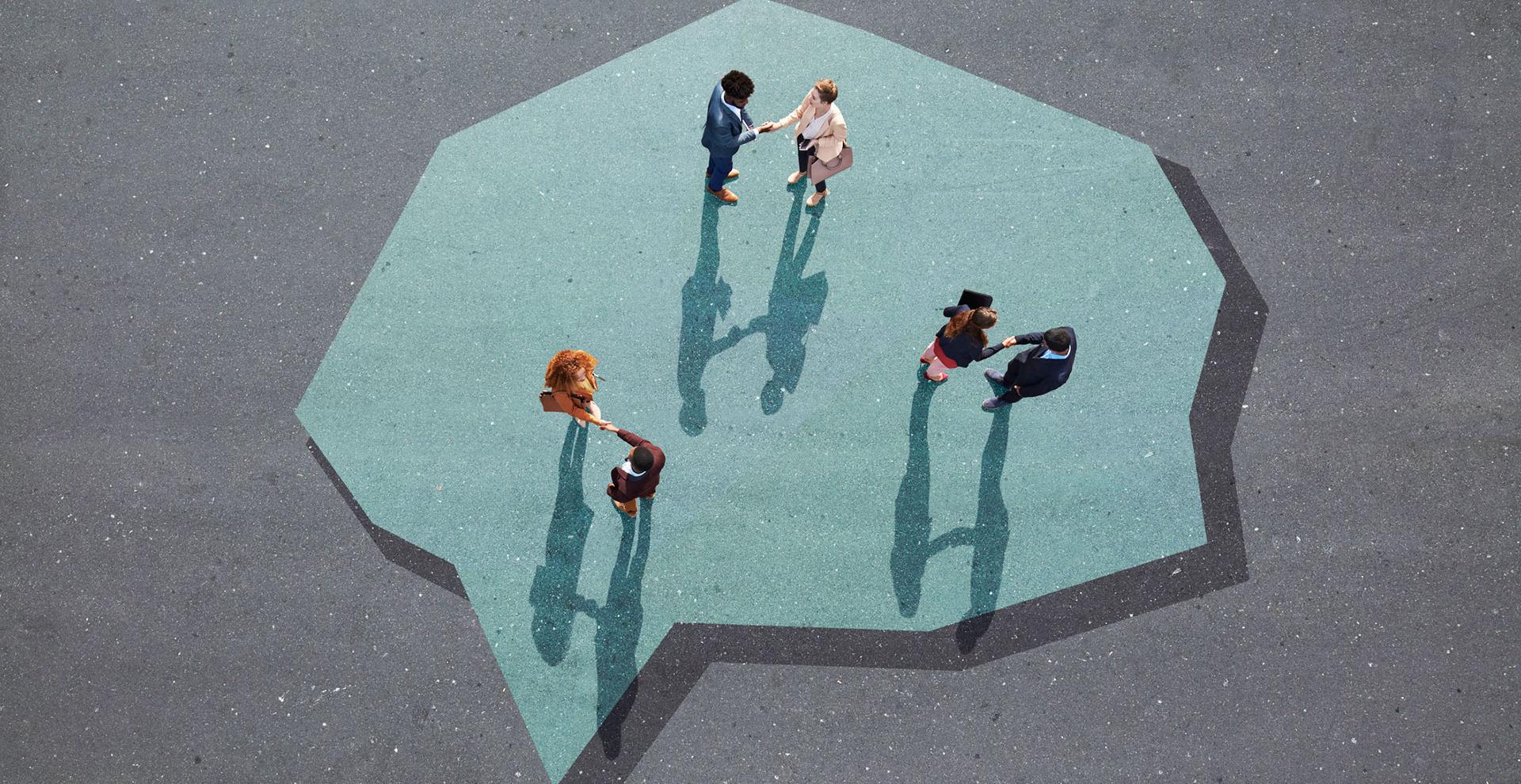 Des groupes de personnes se serrent la main et dialoguent