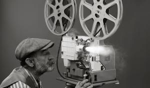 Un homme filmant avec une ancienne caméra de cinéma